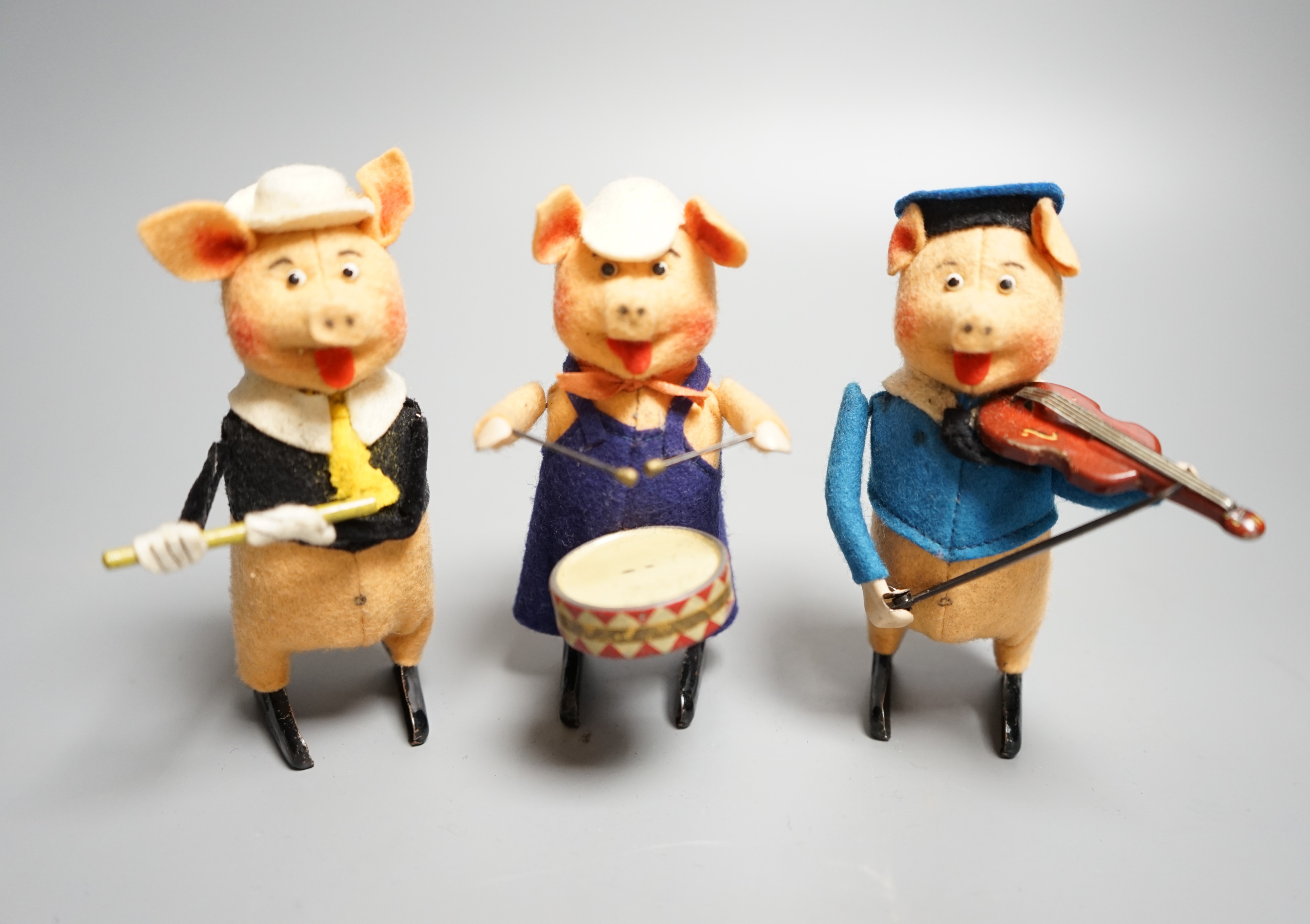 A set of three Schuco tinplate and felt clockwork pig musicians, pre war, tallest 11.5cm